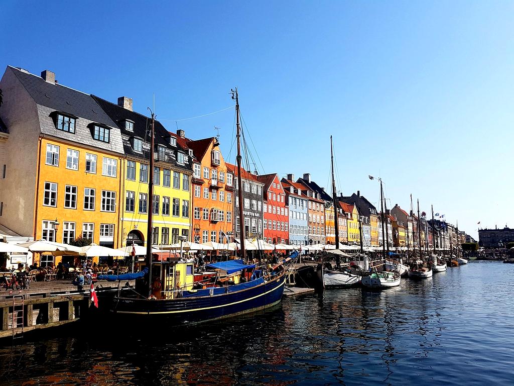 Colorful houses in Nyhavn, Copenhagen reflecting in the water canal
